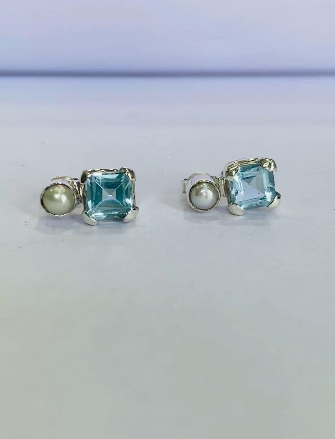 Designed for everyday comfort and sophistication, these gemstone studs are a perfect addition to any jewelry collection The combination of natural blue topaz and freshwater pearls creates a striking contrast, giving these earrings a unique and timeless appeal. Blue topaz is known for its calming energy and clarity-enhancing properties, while freshwater pearls symbolize elegance and purity. This makes these earrings more than just an accessory; they are a meaningful piece of jewelry that enhances the