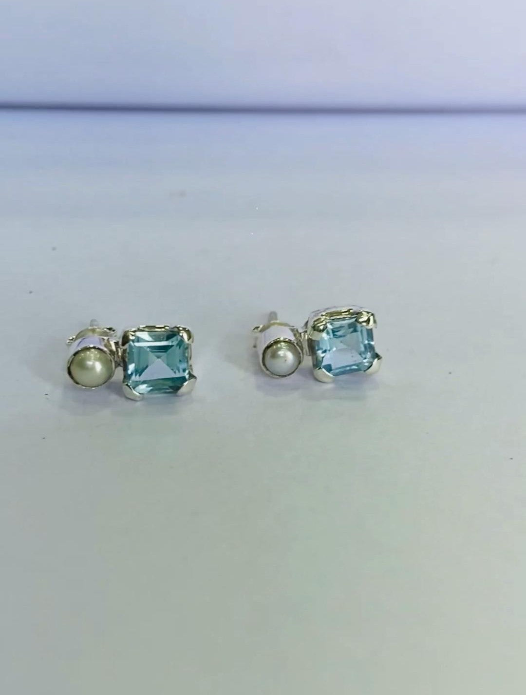 Their timeless appeal makes them a cherished gift for mothers, wives, girlfriends, or sisters. As a December birthstone, blue topaz holds special significance, making these earrings an ideal personalized present for those born in that month. The cushion-cut blue topaz paired with a round freshwater pearl ensures an elegant and trendy look, making these earrings a must-have for women who appreciate fine jewelry.
