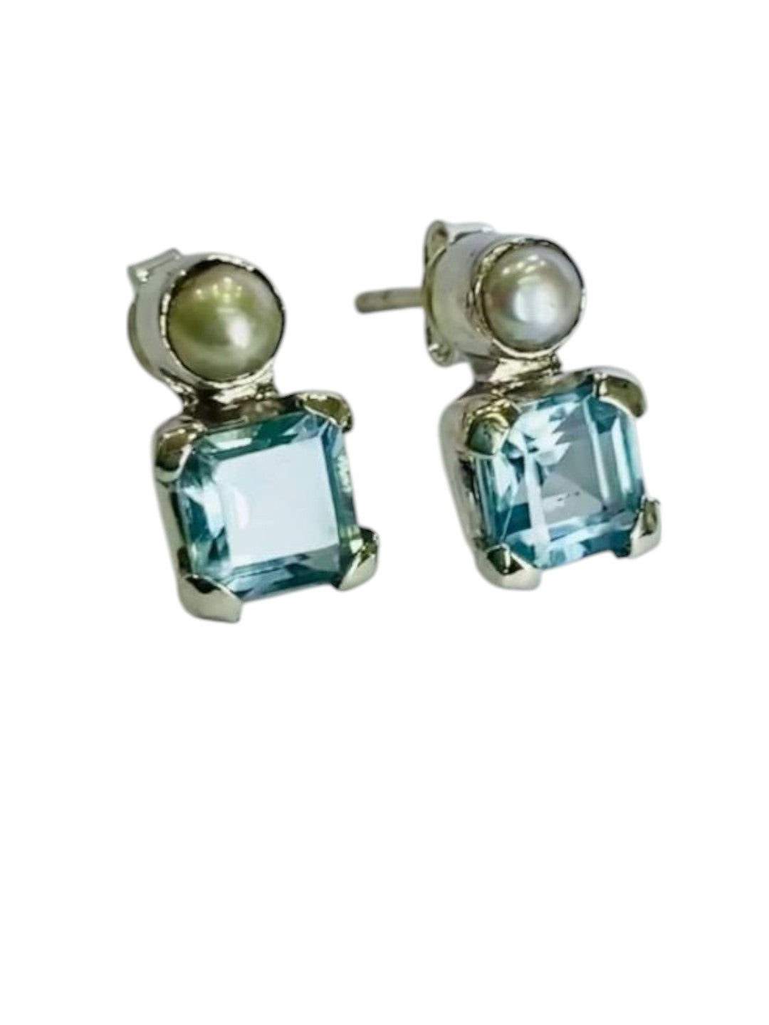 Indulge in the luxury of sterling silver stud earrings featuring natural blue topaz gemstones and freshwater pearls. These exquisite earrings are crafted with genuine 925 sterling silver, ensuring durability, shine, and skin-friendly wear. The silver-plated finish enhances their brilliance, making them an elegant choice for both casual and formal outfits.