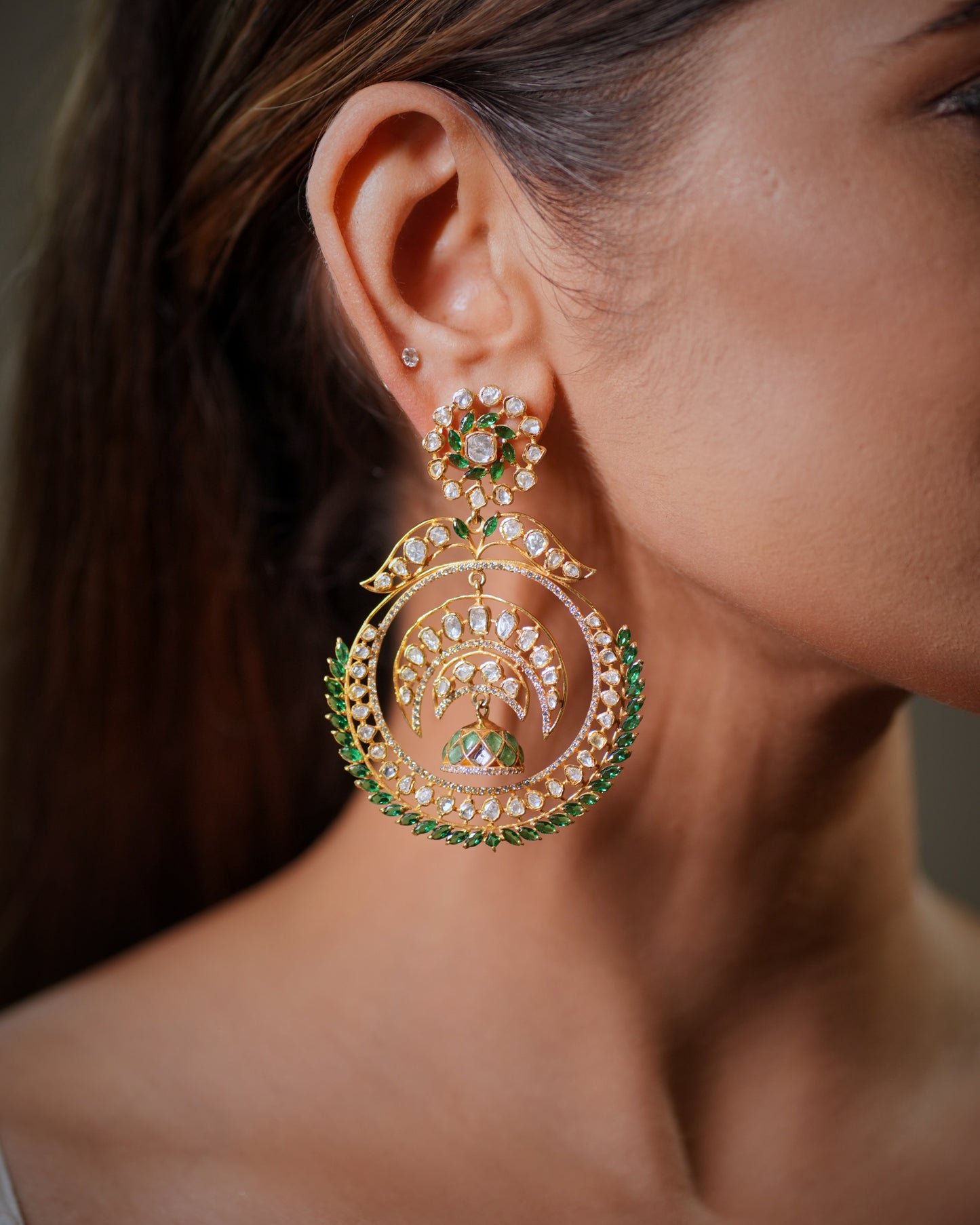 Statement ethnic earrings with fine Polki detailing, handcrafted gemstone setting and antique gold aesthetics. Luxury Indian bridal earrings suitable for wedding trousseau collections, festive wear and designer ethnic fashion styling.

Royal Indian wedding earrings handcrafted with Moissanite Polki stones and emerald gemstones, luxury bridal jewelry for women who love traditional handcrafted artistry. Designer bridal Chandbali earrings inspired by Mughal and Bollywood fashion trends, featuring detailed arti