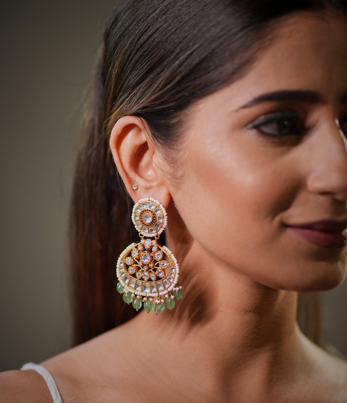 Combined with green emerald stones, these earrings create a rich royal color combination that complements Indian skin tones beautifully and enhances bridal makeup looks. Emerald jewelry is also considered auspicious and luxurious in Indian bridal fashion, making emerald Chandbali earrings one of the most popular wedding jewelry trends in Jaipur and across India.