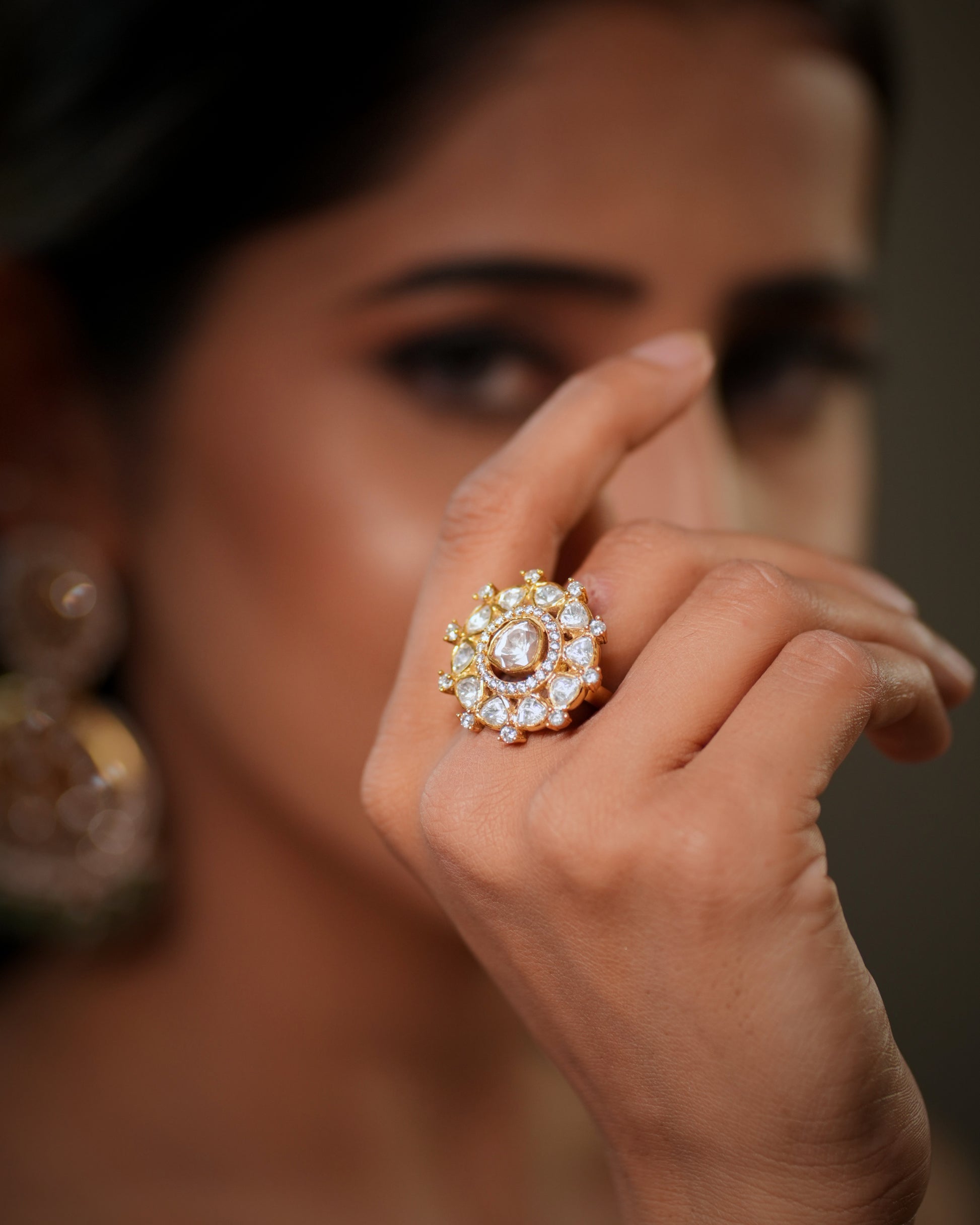 This luxurious Moissanite Polki Ring in 925 Sterling Silver with 22k Gold Plated finish is a perfect blend of royal Indian craftsmanship and modern elegance. Designed with sparkling polki stones and premium moissanite detailing, this adjustable cocktail ring adds timeless beauty to every bridal, festive, and party look. Inspired by traditional Jaipur jewellery artistry, this handcrafted statement ring reflects the grandeur of royal heritage jewellery while offering the comfort of contemporary fashion jewell