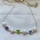 This necklace features a stunning blend of natural amethyst, peridot, and blue topaz stones set alongside lustrous freshwater pearls.
The gemstones are cushion-cut for a modern, elegant look, paired beautifully with round pearls for added charm.
Each stone is prong-set in 925 sterling silver, ensuring durability and a premium finish.
The alternating gemstone and pearl pattern creates a vibrant yet balanced aesthetic.
Designed for both casual and semi-formal wear, this piece adds color and grace to any outfi