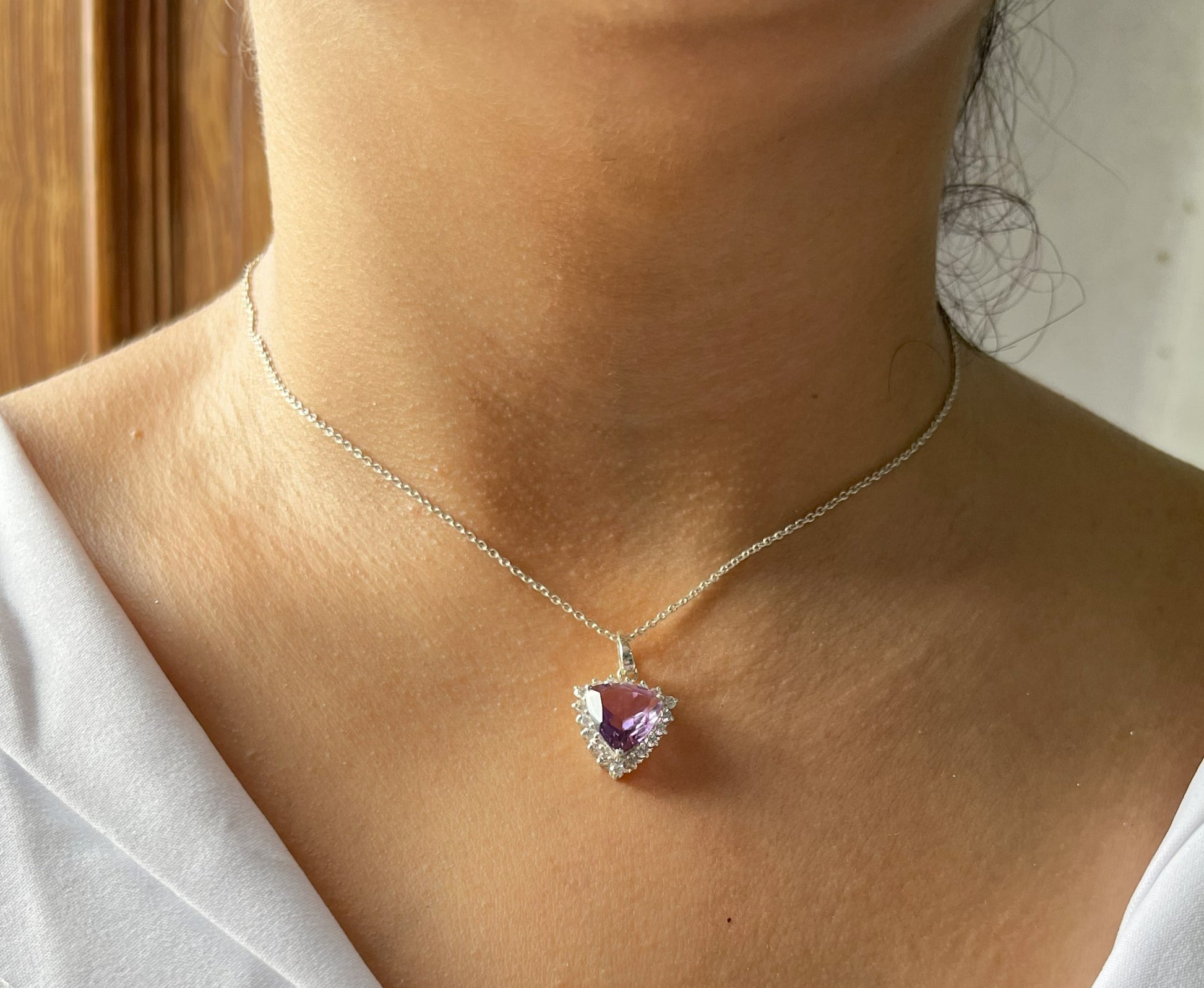 The round simulated diamonds surrounding the amethyst add extra brilliance, making this piece perfect for both minimalist jewelry collections and statement jewelry lines. The delicate 18-inch adjustable chain ensures versatility, allowing the necklace to complement various necklines and styles.

Ideal for designers and brands specializing in semi-precious gemstone jewelry, this pendant is crafted in a state-of-the-art jewelry production facility, where every detail is refined to meet international quality s