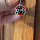 This Jagannath Pendant, handcrafted in 925 Sterling Silver, features the vibrant and iconic face of Lord Jagannath. The hand-painted enamel design in black, red, and white brings the deity to life, symbolizing divine blessings, positivity, and spiritual strength. Framed with a silver-plated gold-tone border, this religious pendant is a perfect blend of tradition and craftsmanship. Known as a protective talisman, it is ideal for those seeking good luck and sacred blessings.