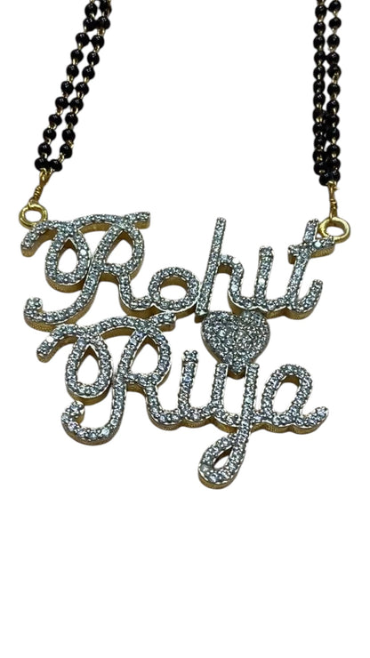 Celebrate the eternal bond of love with our exquisitely handcrafted Customized Couple Name Mangal Sutra, where elegance meets personal expression. Designed for those who believe that love deserves to be worn close to the heart, this piece of jewelry captures the essence of togetherness in the most personalized way — with your names, your story, immortalized in shimmering brilliance. Made from high-quality 925 sterling silver or brass and finished with a rich 22k gold polish, this Mangal Sutra is more than 
