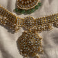 Pair it with a Kanjeevaram saree, Banarasi silk, or a heavy embroidered lehenga to complete the perfect festive or bridal look. It is ideal for Hindu weddings, pujas, housewarming ceremonies, or any religious function, symbolizing shringar and devotion. The emerald and pearl bead knitting flows gracefully along the neckline, creating a fluid and goddess-like form that enhances your aura and style simultaneously.
Gifting this necklace is an act of pure love and thoughtful intention. In Sanatan Dharma, jewel