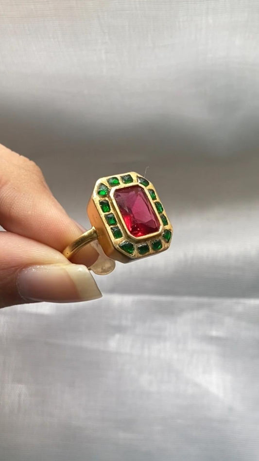 Adorned with vibrant red and green Polki stones, set meticulously in a luxurious silver base, it showcases intricate craftsmanship that makes it perfect for grand occasions like weddings, festivals, and family celebrations.

Crafted from certified 925 sterling silver and stamped for authenticity, this traditional Polki silver ring promises both quality and luxury. 