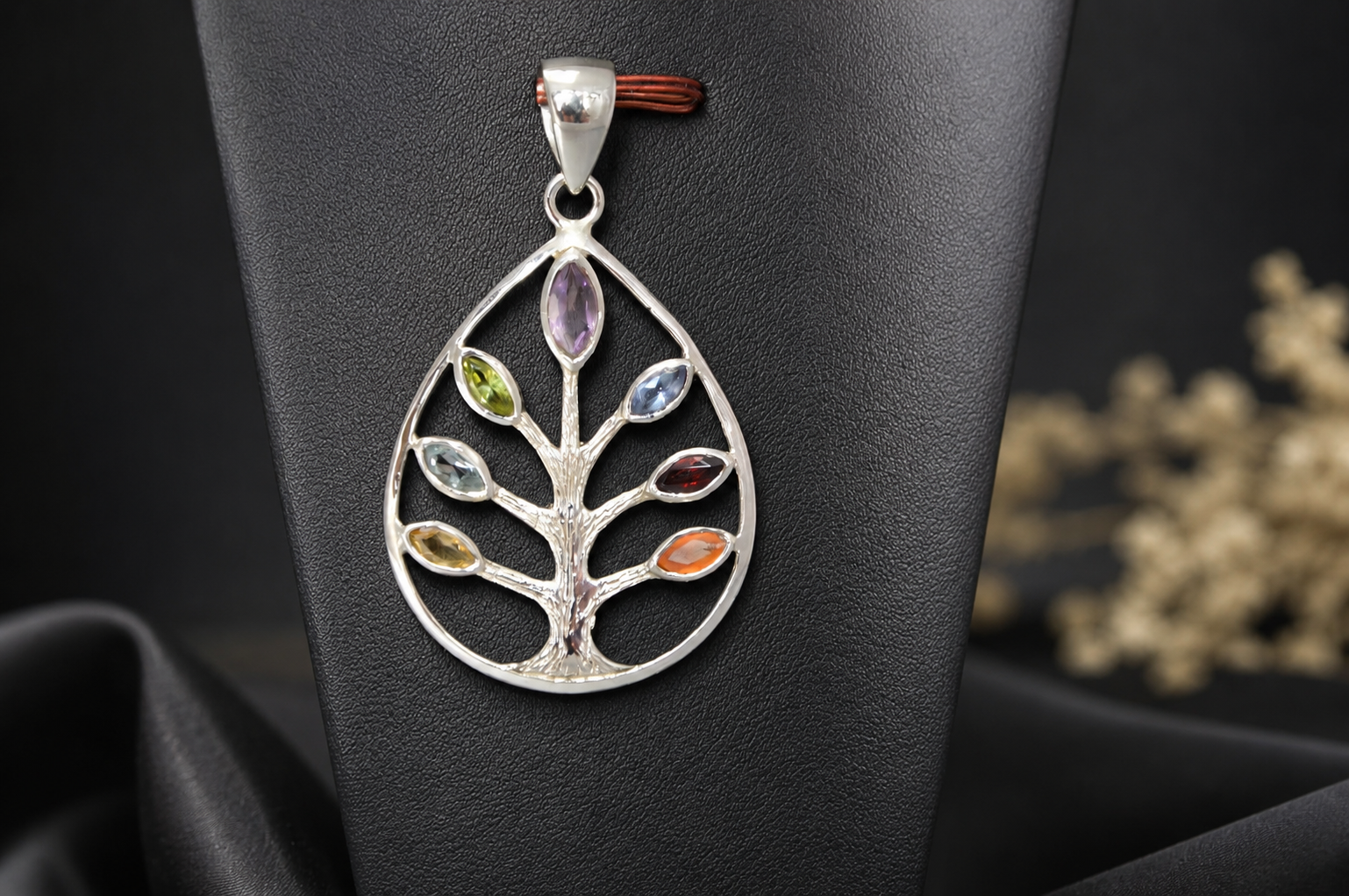 Crafted from durable, hypoallergenic sterling silver, the openwork design features intricate bark texturing and a brilliant polish that illuminates the vibrant gemstones from every angle. Its perfectly balanced, unisex aesthetic ensures it looks equally striking on men and women, making it a versatile piece that effortlessly transitions from a casual daytime look to elegant evening wear.